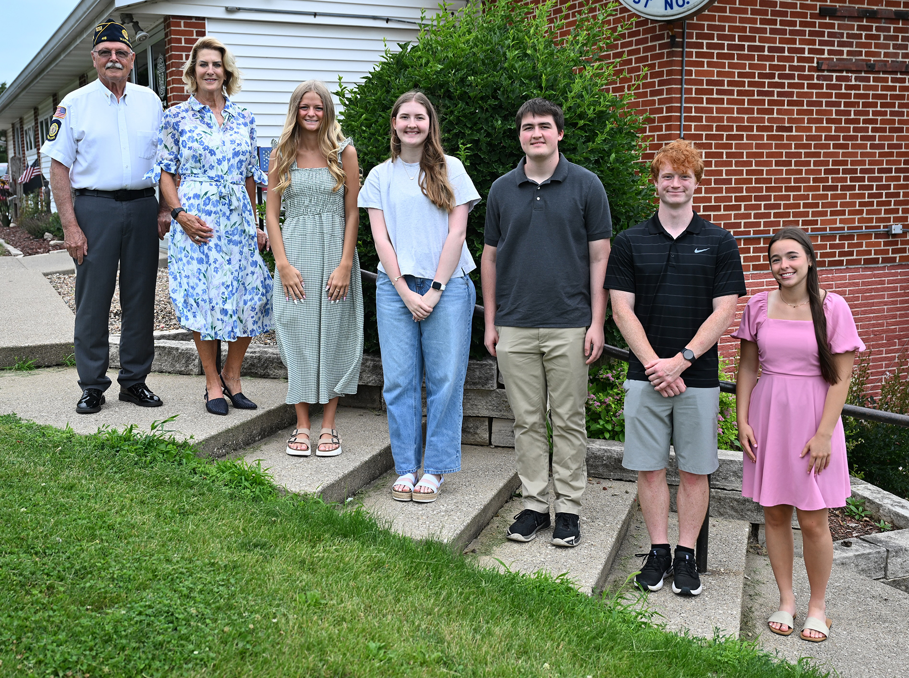 Robert Miller, Kelley Fifer Fairall, Kaylie Andrews, Isabelle Rawlins, William Rawlins, Jayden Beichley, and Elizabeth Downs standing on stairs outdoors