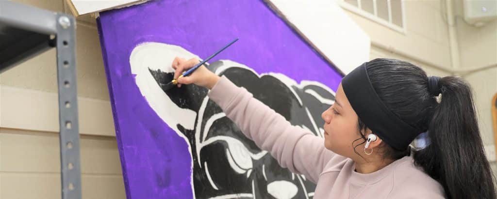 Graphic-design-student-painting-a-panther.