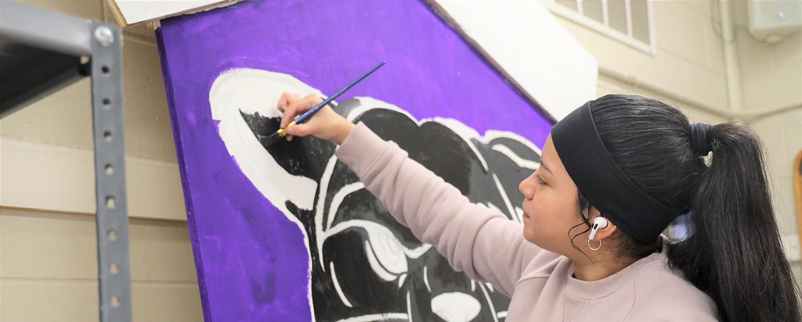 Graphic-design-student-painting-a-panther.