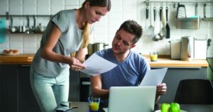 a-stock-photo-of-a-woman-showing-a-man-a-piece-of-paper