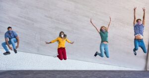 a-stock-photo-of-four-people-jumping-in-the-air-together