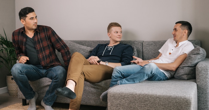 a-stock-photo-of-three-men-sitting-on-a-couch