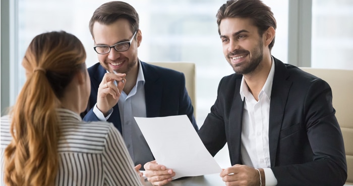 a-stock-photo-of-two-men-interviewing-a-woman