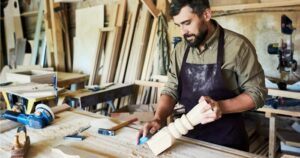 a-stock-photo-of-a-man-building-an-object-out-of-wood