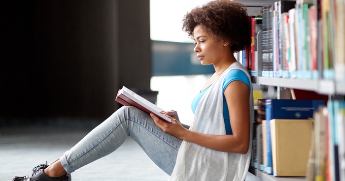 a-stock-photo-of-a-woman-reading-in-a-library