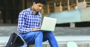 a-stock-photo-of-a-man-sitting-down-with-his-laptop