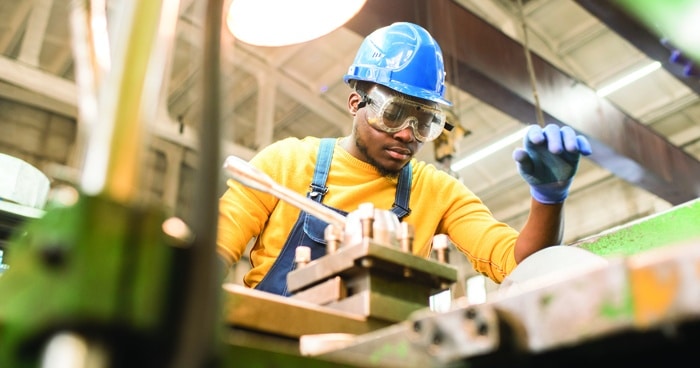 a-stock-photo-of-an-assembly-line-worker-wearing-a-hard-hat-and-safety-goggles