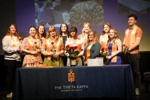 PTK-members-standing-on-the-stage-in-hamilton-auditorium.