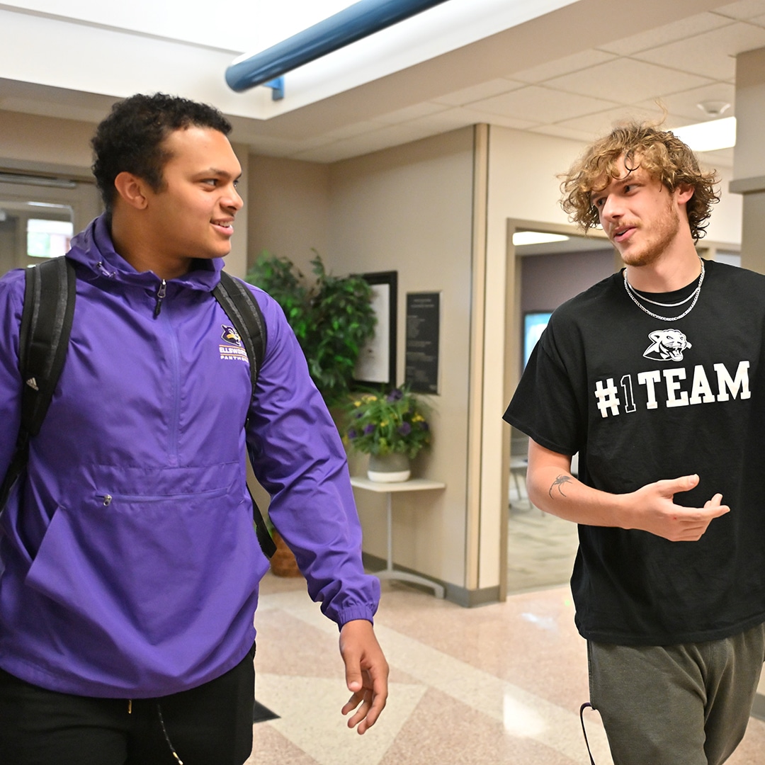 Two-students-walking-in-the-hall.